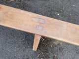 a wooden bench that is sitting on the ground