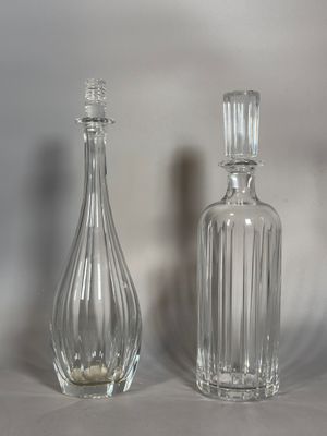 deux bouteilles en verre posées l'une à côté de l'autre sur une table