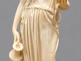 statue of a woman holding a pitcher and a bowl
