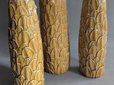 three vases that are sitting next to each other on a table