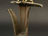 statue of a lion on top of a vase with a stone base