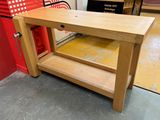 a wooden table with a drawer underneath it in a room
