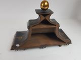 a wooden shelf with a golden ball on top of it