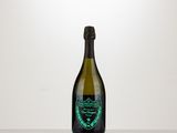 the bottle of champagne is sitting on a table with a white background