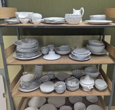 a lot of plates and bowls on a shelf