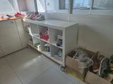 many boxes of shoes on the floor in this room
