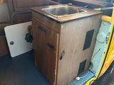 a small sink in the back of a camper van
