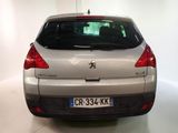 the rear end of a silver car in a white room