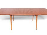 a wooden table with two leaves on the top of it