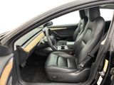 the interior of a car with the door open and the driver ' s seat down