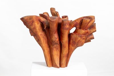 a sculpture of a bunch of wood sticks on a white pedestal