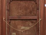 an old wooden frame with a rope hanging from it ' s sides