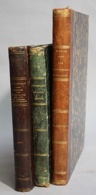 three old books that are stacked on top of each other