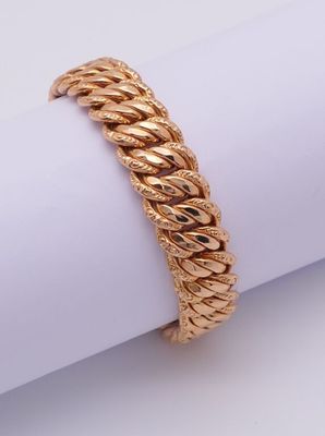 a close up of a gold bracelet on top of a napkin