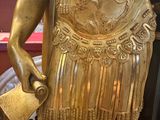 a statue of a man holding a book in his hand