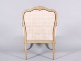 a wooden chair with a pink and white striped upholstered back