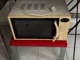 a microwave that is sitting on a red table