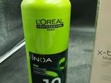 a bottle of l ' oreal in a box next to a bottle of inoa