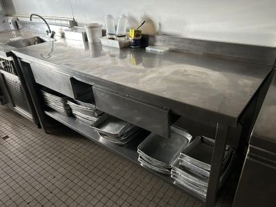 a kitchen with a sink and a counter with dishes on it