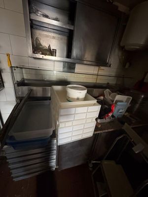 an image of a kitchen with a lot of clutter on the counter