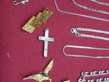 a lot of silver and gold jewelry on a red table