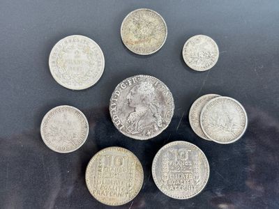 six different coins are arranged in a circle on a black surface