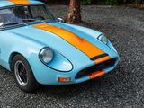 a blue and orange sports car parked in a parking lot