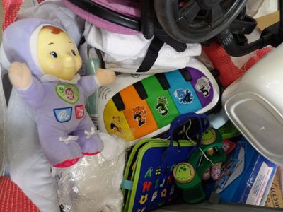a baby in a stroller with a toy in it
