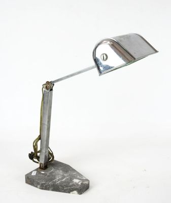 a metal lamp that is sitting on a marble base