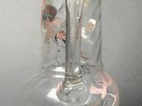a clear glass vase with a flower design on it
