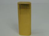 a gold vase that is sitting on a white surface