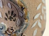 a close up of a vase on a table