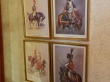 three framed pictures of soldiers on a wall in a hallway