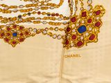 an image of a gold necklace and a pair of earrings on a table