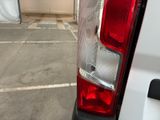a white van parked in a parking lot next to a building