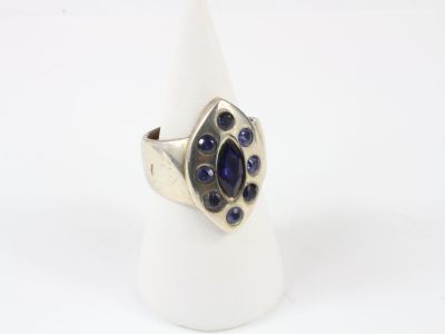 silver ring with blue stones on a white surface