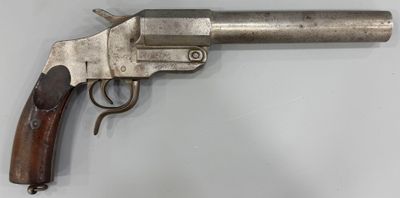 un revolver en argent avec une poignée en bois sur une surface blanche