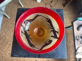 a red bowl with a black and white design on it