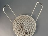 a close up of a metal wire basket with two handles