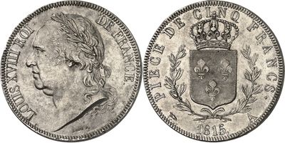 a silver coin with a crown on top of it