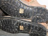 a close up of a pair of shoes on top of a pile of luggage