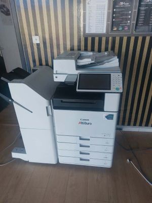 a printer that is sitting on the floor in front of a wall