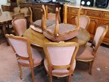 a large dining room table with chairs and a centerpiece