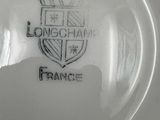 a white plate with a picture of a coat of arms on it