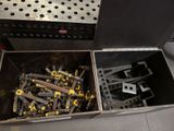 many screws in a metal box on the floor
