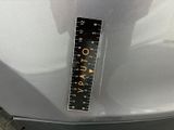 a sticker on the hood of a car that has a ruler attached to it
