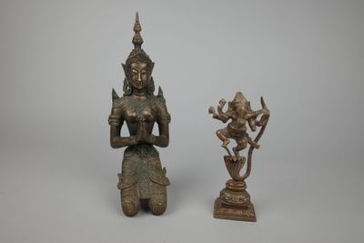 two bronze figurines of a woman holding a flower and a bird