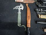 many different types of knives laid out on a table