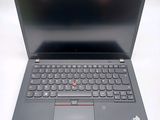 the laptop is open on a white surface with a black keyboard