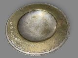 a silver plate with a hole in the middle of it